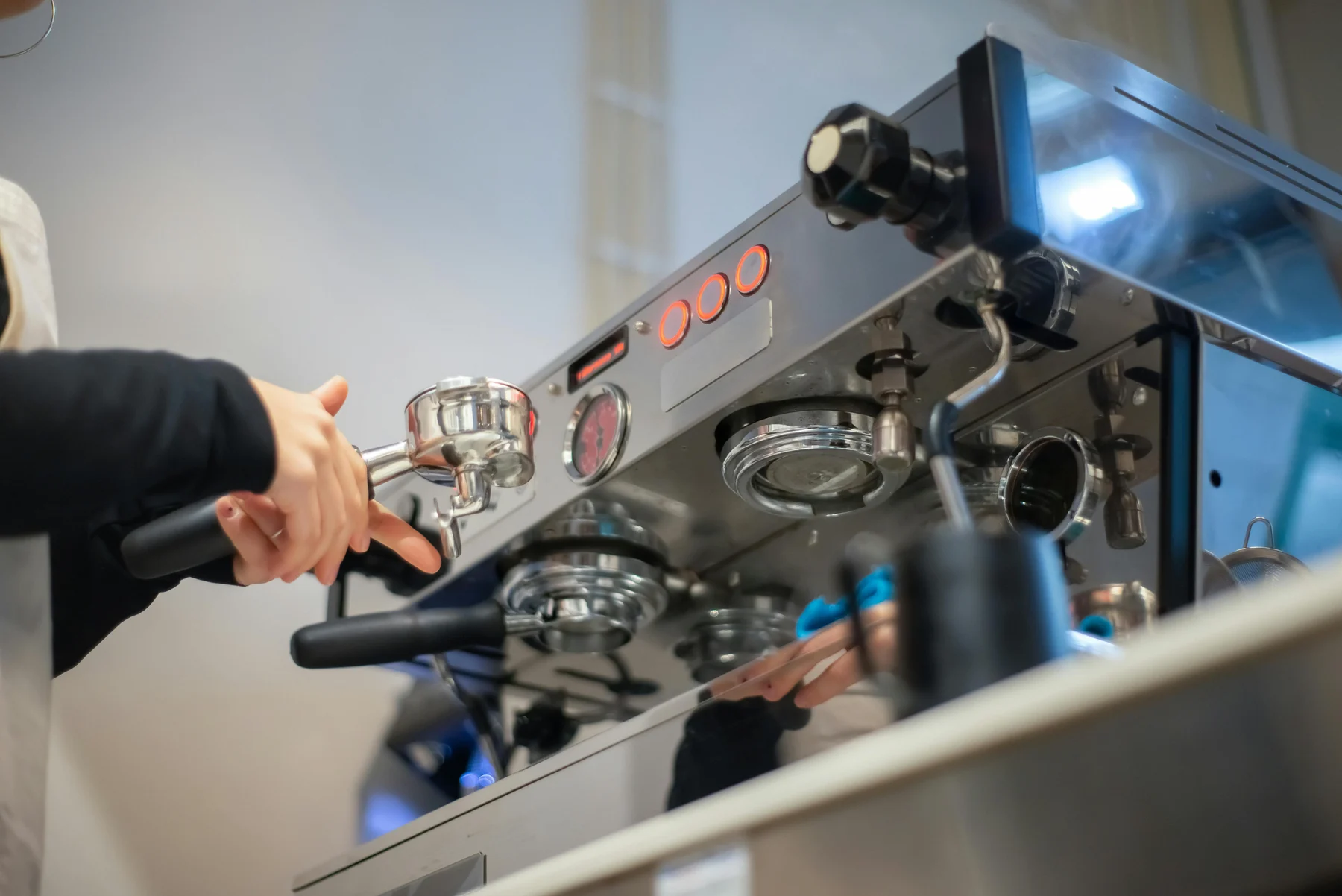 Barista preparing coffee on a commercial machine